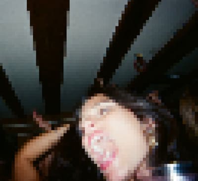 Pixelated low-angle shot of a person with mouth open under dark ceiling beams