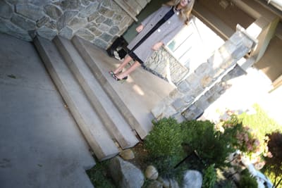 Steeply tilted shot of a model standing at the top of porch steps