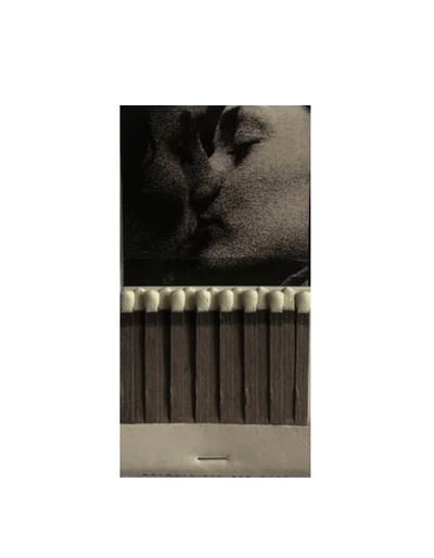 Open paper matchbook with a grainy black-and-white image of a kiss on the cover